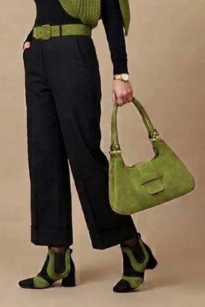 Women's pitch black and pistachio green two-tone chelsea boots with round toe and low flared heel - Worn view